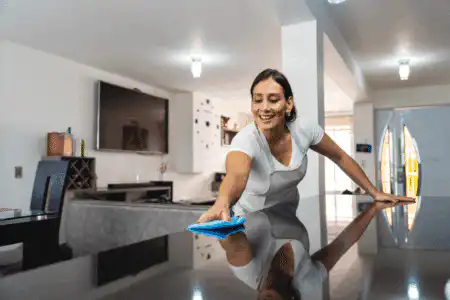 Residential cleaning team polishing a modern kitchen island in a Richmond home.